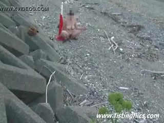 Crazy anal and pussy insertions at the beach
