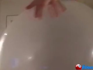 Ms in black blows up giant balloon